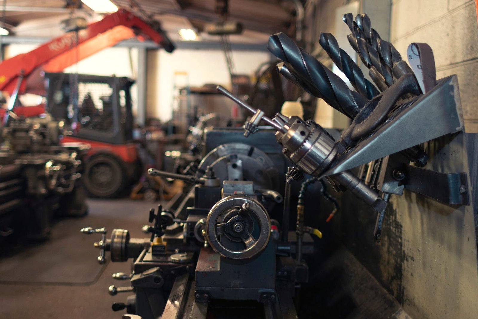 Shop tooling stored on a rack with machinery behind it